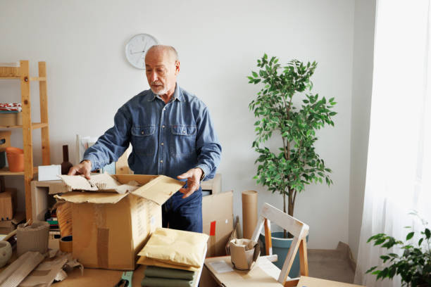 Senior man getting order ready for delivery at his home based workshop stock photo